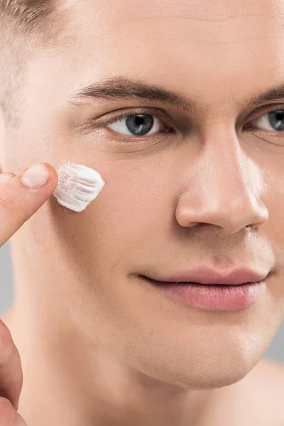 Close View Young Man Applying Face Cream Looking Away — Stock Photo, Image