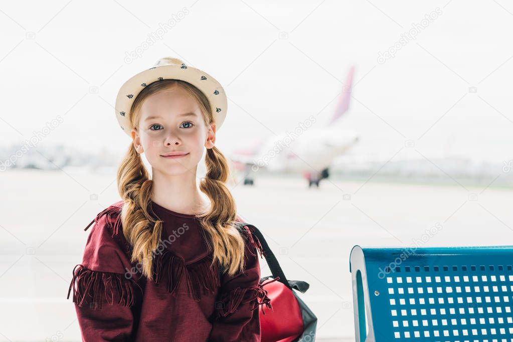 adorable preteen kid looking at camera in airport