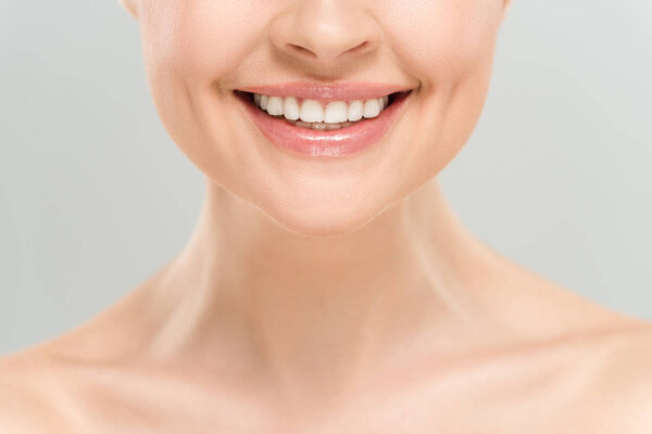 cropped view of happy naked woman smiling isolated on grey 