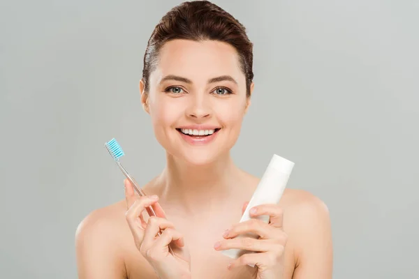 Positive Woman Smiling While Holding Toothbrush Tube Toothpaste Isolated Grey — Stock Photo, Image