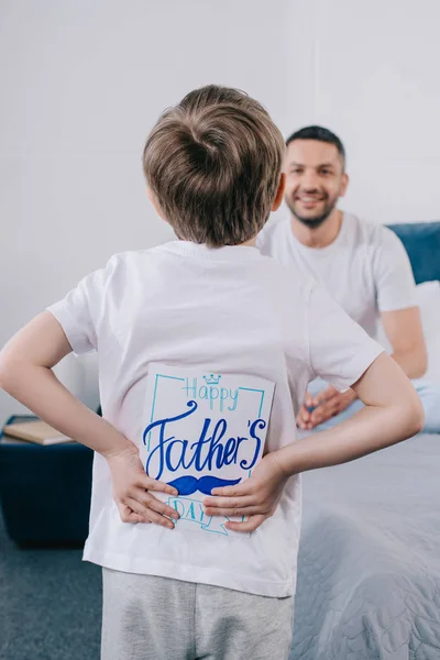 Selective Focus Son Holding Fathers Day Greeting Card While Standing — Stock Photo, Image