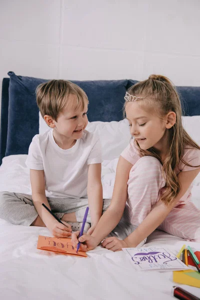 Adorable Children Drawing Fathers Day Greeting Cars While Sitting Bedding — Stock Photo, Image