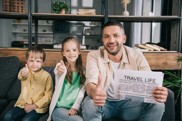 Happy Family Showing Thumbs While Father Holding Travel Life Newspaper — Stock Photo, Image