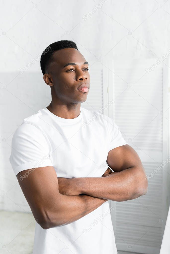 confident african american man crossed arms on his chest and looking away
