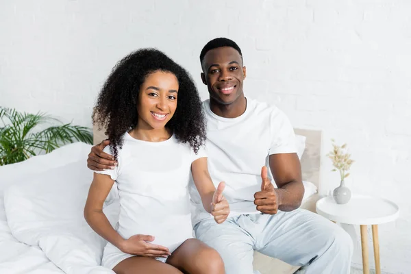 African American Couple Sitting Bed Gesturing Thumbs — Stock Photo, Image
