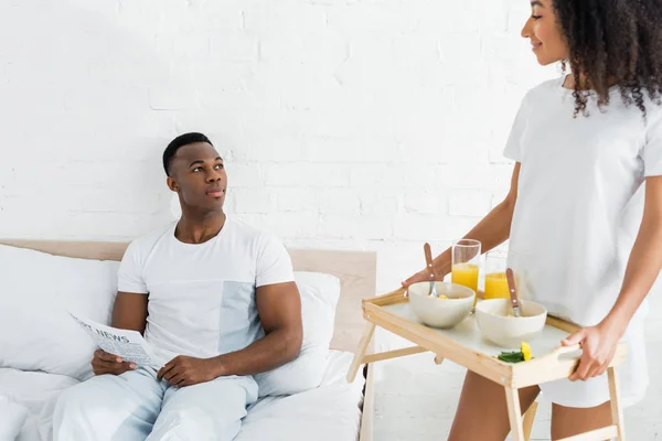 Calm African American Man Lying Bed Looking Girlfriend Tray Hands — Stock Photo, Image
