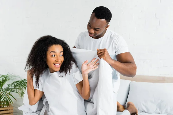 African American Man Covering Girlfriend White Blanket — Stock Photo, Image