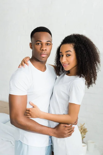 African American Couple Cuddling Each Other Standing White Room Looking — Stock Photo, Image