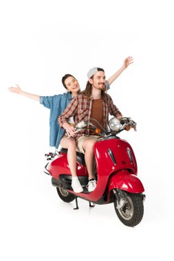 full length view of couple of young tourists riding on red scooter holding hands in air isolated on white clipart