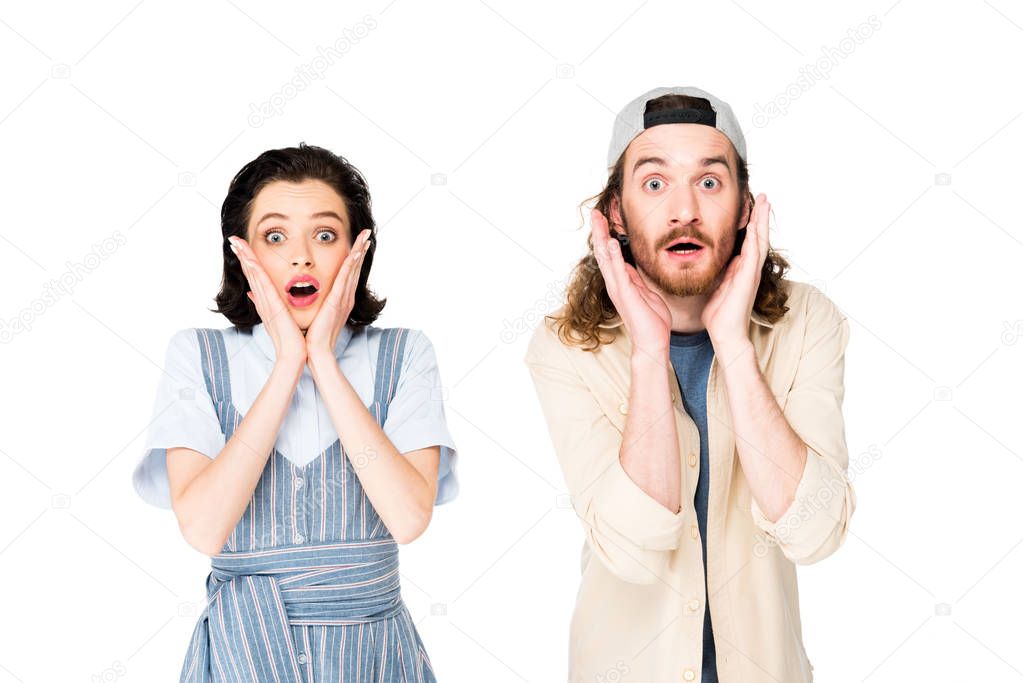 shocked young man and girl looking at camera isolated on white