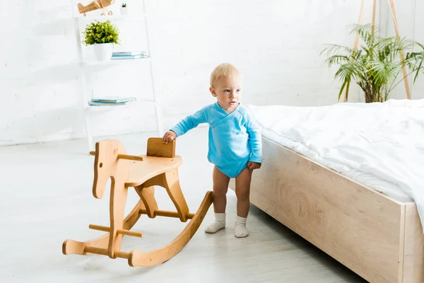 Adorable Toddler Kid Standing Wooden Rocking Horse Modern Bedroom — Stock Photo, Image