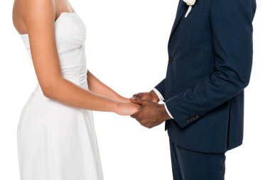 cropped view of african american bride and bridegroom holding hands isolated on white  clipart