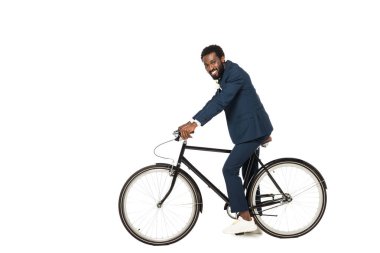 happy african american bridegroom riding bicycle isolated on white  clipart