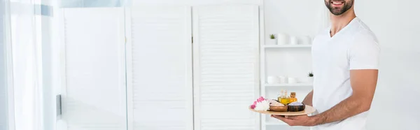 Panoramic Shot Bearded Smiling Man Holding Tray Bottles Oil Bowls — Stock Photo, Image