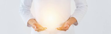 panoramic shot of healer standing and gesturing near light isolated on white  clipart