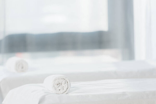 selective focus of massage table with towel in spa center 