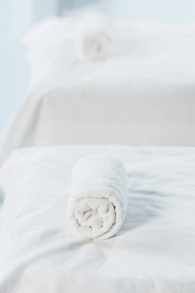 selective focus of massage table with white towel in spa center 