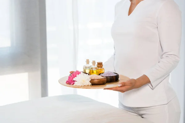 Cropped View Woman Holding Tray Bottles Oil Sea Salt Flowers — Stock Photo, Image