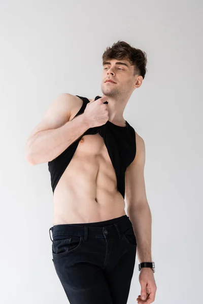 Sexy Muscular Man Black Sleeveless Shirt Showing Torso Isolated Grey — Stock Photo, Image