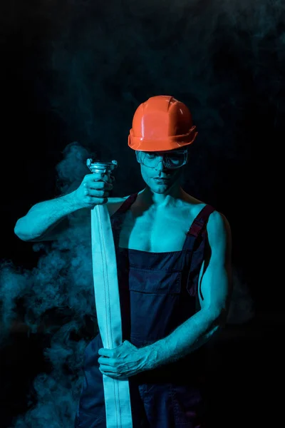 Sexig Brandman Hardhat Och Skyddsglasögon Håller Brand Slang Rök Svart — Stockfoto