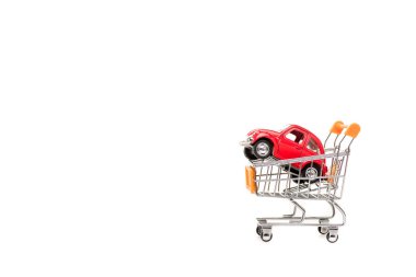 red toy car in shopping cart isolated on white clipart