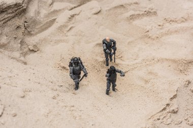 plastic toy soldiers on sand dune with guns clipart