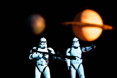 white imperial stormtroopers with guns and cosmic planets on background