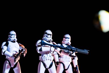 white imperial stormtroopers with guns on black background with blurred planet Earth