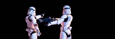 toy white imperial stormtroopers with gun isolated on black