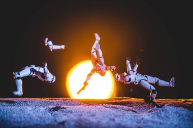 white plastic Imperial Stormtrooper levitating in space on black background with sun