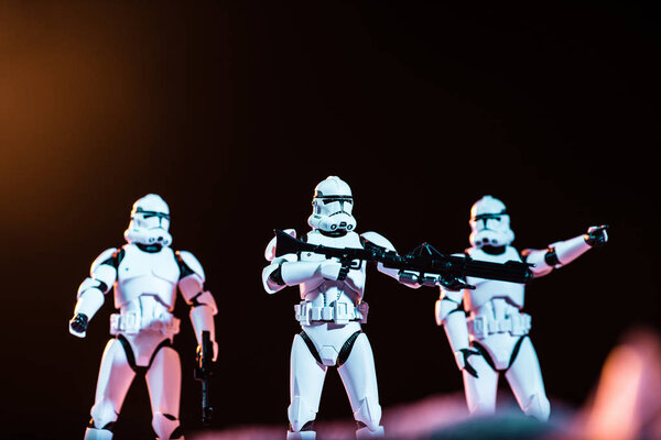 KYIV, UKRAINE - MAY 25, 2019: selective focus of white imperial stormtroopers with guns on cosmic planet