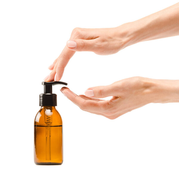 cropped view of woman pumping soap from dispenser bottle isolated on white 