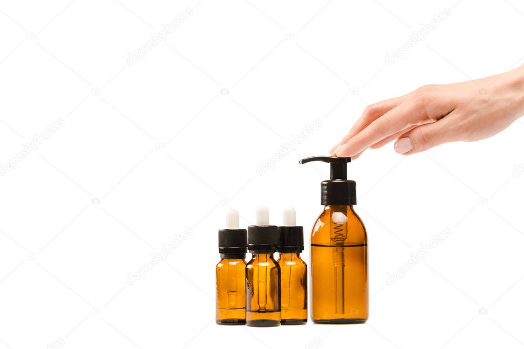 cropped view of woman touching dispenser bottle isolated on white 