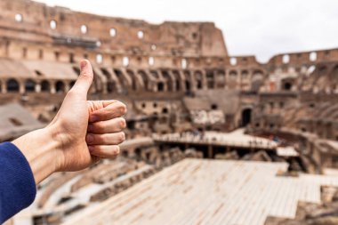 Roma, İtalya - 28 Haziran 2019: Kolezyum'un önünde başparmak gösteren adamın kısmi görünümü