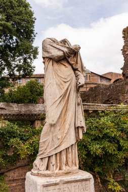 ROME, ITALY - JUNE 28, 2019: ancient headless statue under blue sky  clipart
