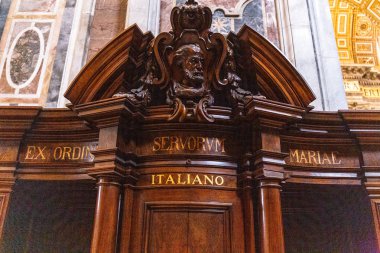 ROME, ITALY - JUNE 28, 2019: confession booth in basilica of St. Peter in Vatican  clipart