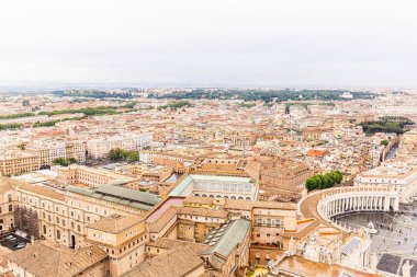 ROME, ITALY - JUNE 28, 2019: aerial view of tourists near buildings and trees under grey sky  clipart
