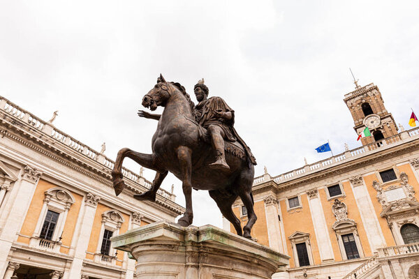ROME, ITALY - JUNE 28, 2019: bottom view of statue of marcus aurelius under grey sky