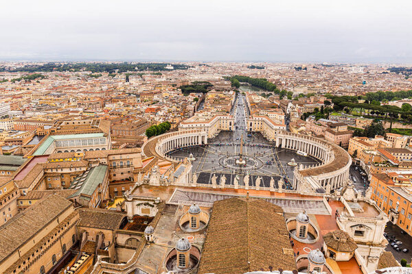 ROME, ITALY - JUNE 28, 2019: aerial view of buildings and trees under grey sky