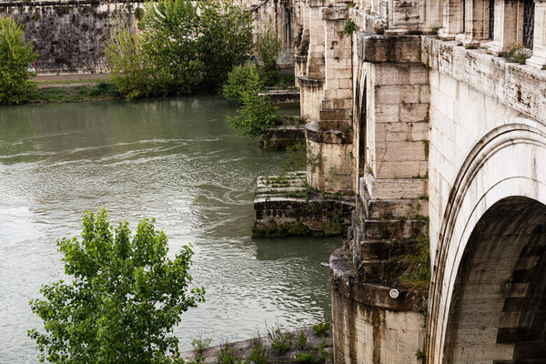 ROME, ITALY - JUNE 28, 2019: river Tiber under old bridge