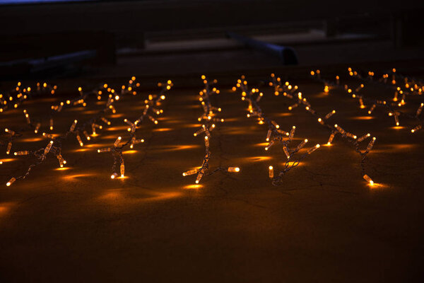 illumination with light bulbs garland on wall in rome, italy