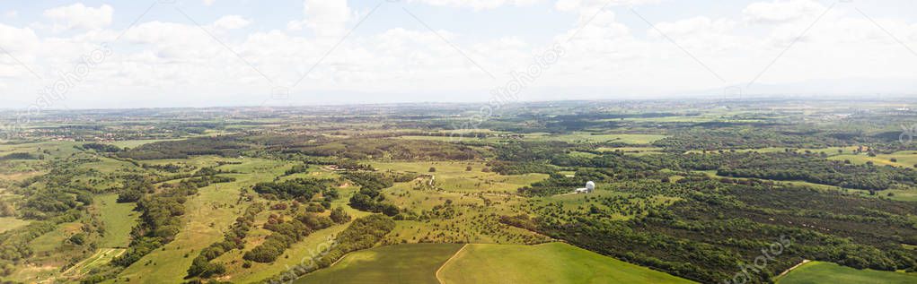 panoramic shot of beautiful landscape with green hills under blue sky with clouds in rome, italy