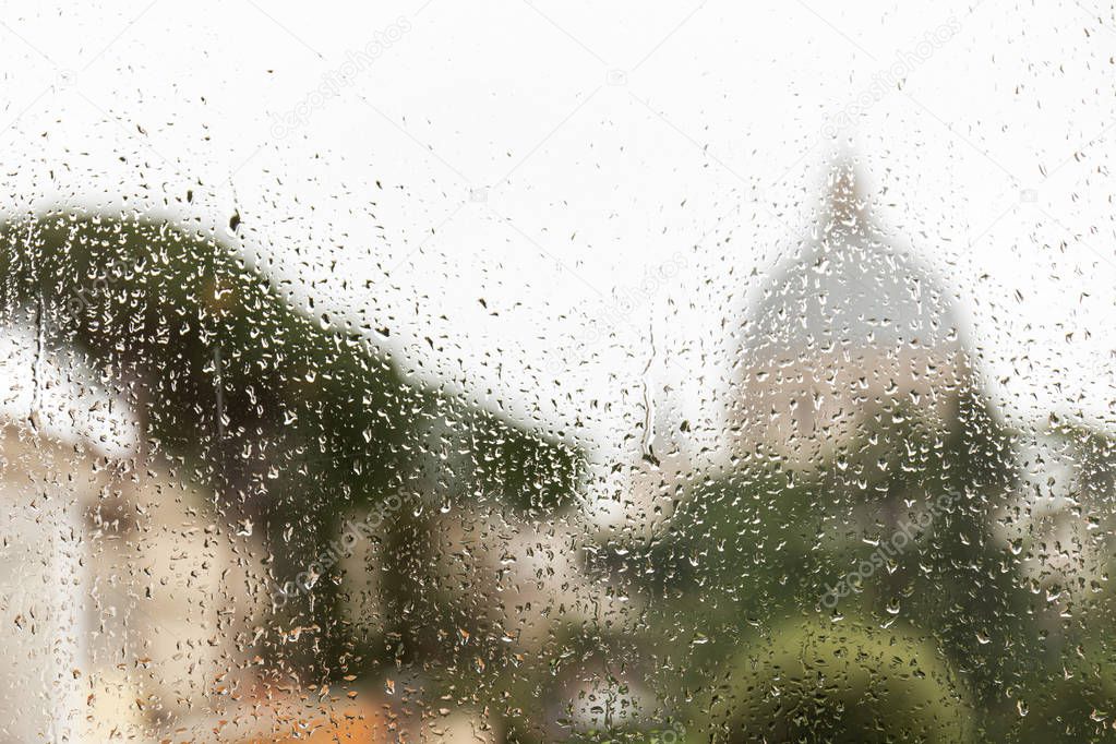 window glass with rain drops in rome, italy