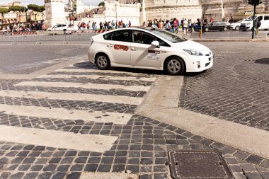ROME, ITALY - JUNE 28, 2019: crowd of people and cars on pavement in sunny day clipart