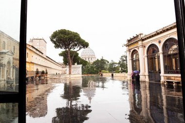 Roma, İtalya - 28 Haziran 2019: Eski binaların yakınındaki meydanda yağmur altında insanlar