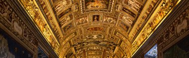 ROME, ITALY - JUNE 28, 2019: panoramic shot of golden ceiling with frescoes clipart