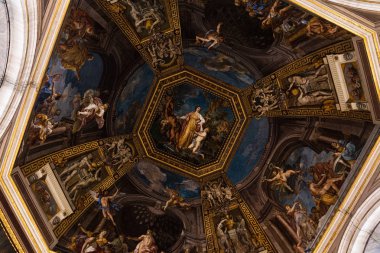 ROME, ITALY - JUNE 28, 2019: bottom view of ceiling with old frescoes in vatican clipart