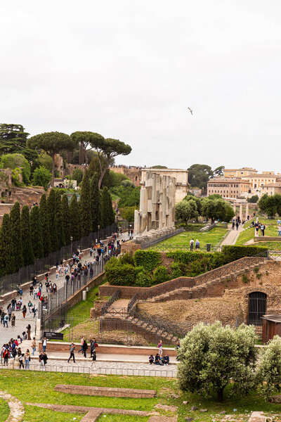 ROME, ITALY - JUNE 28, 2019: crowd of tourists walking at roman forum
