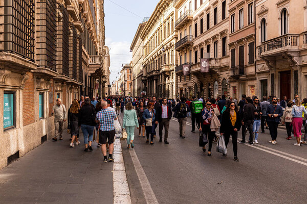 ROME, ITALY - JUNE 28, 2019: crowd of people walking on street near old buildings