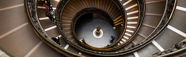 ROME, ITALY - JUNE 28, 2019: panoramic shot of people on Bramante Staircase in vatican museums
